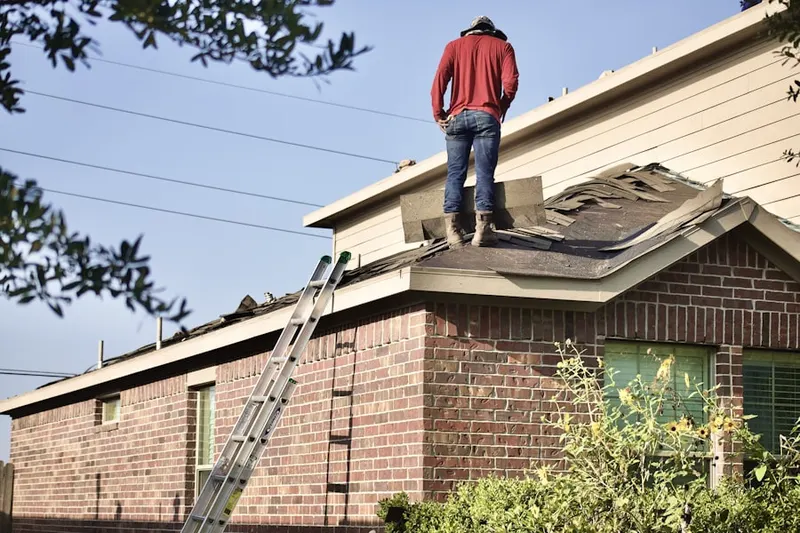 Professional roofer working on a residential roof in Olde Grove Farm
